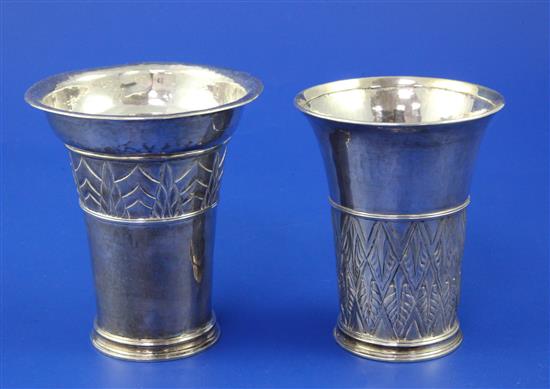Two 1930s Arts & Crafts silver beakers.